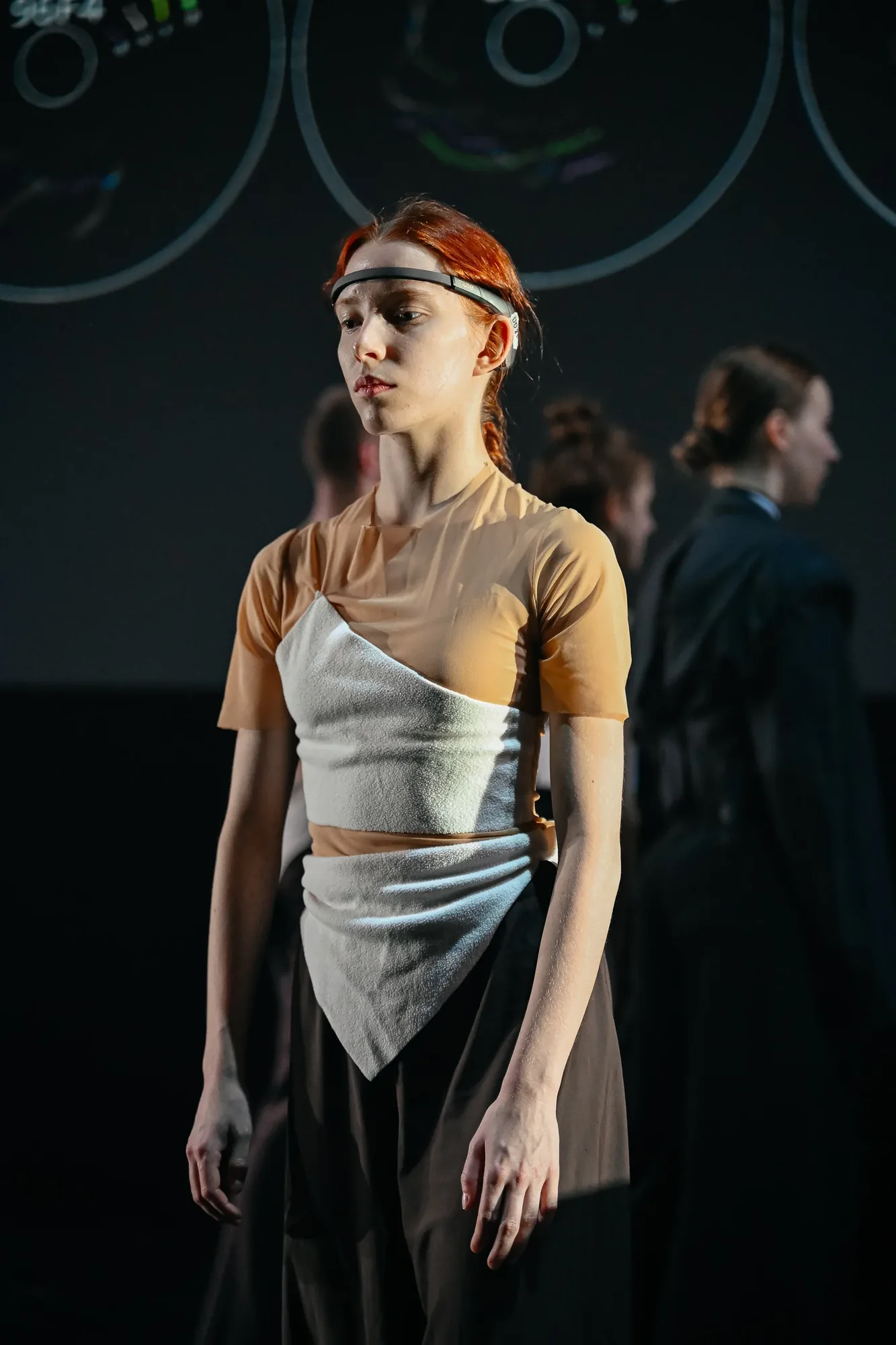 A dancer wearing a neurointerface on stage.