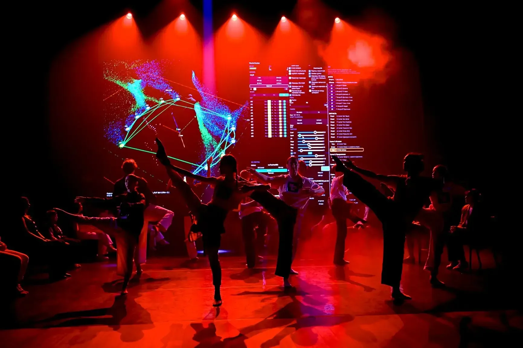 Dancers on a stage lit in red.