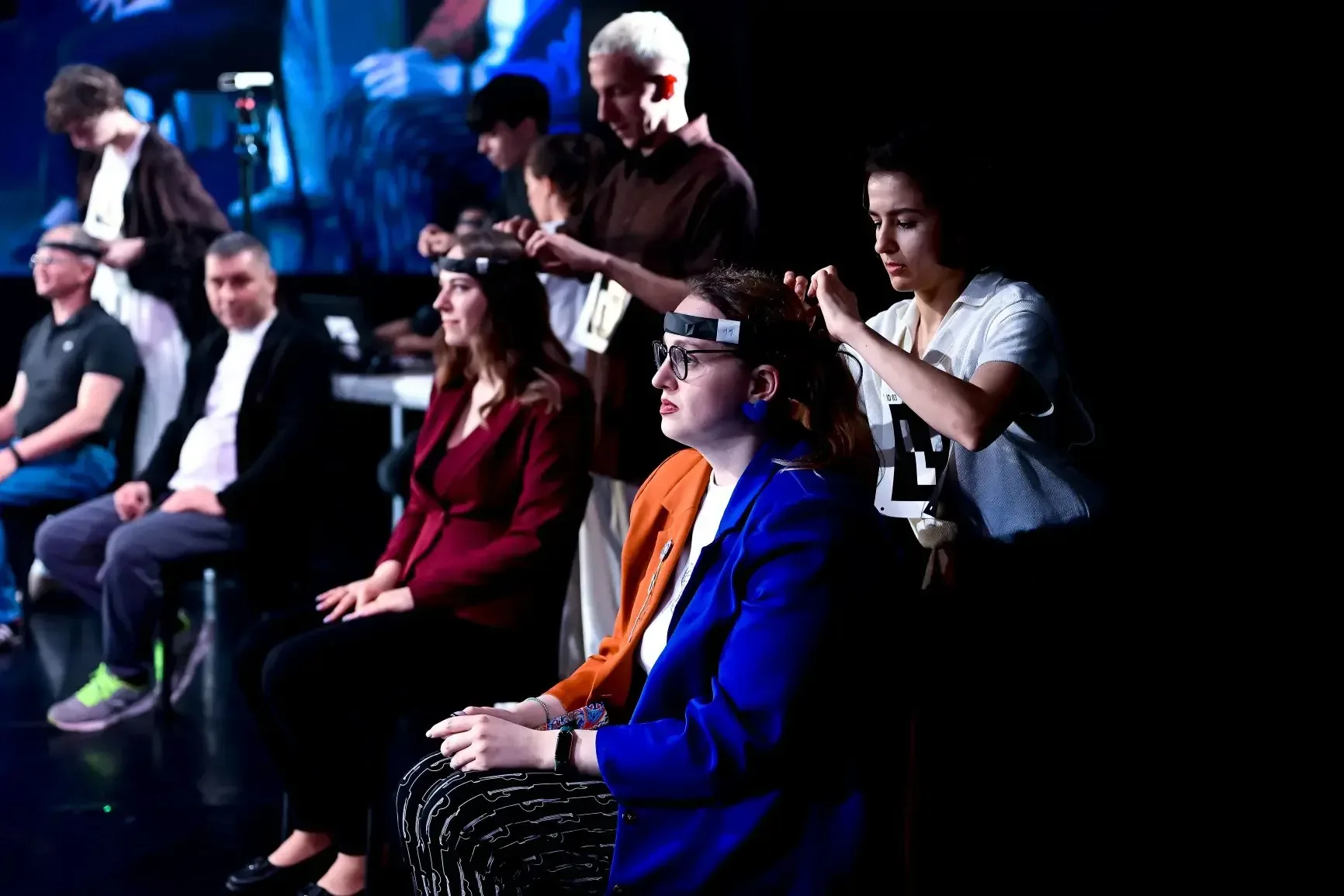 Audience members being fitted with neurointerfaces in the theatre.